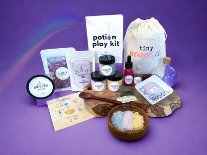 Potion play kit with unicorn theme placed with various items on a purple background
